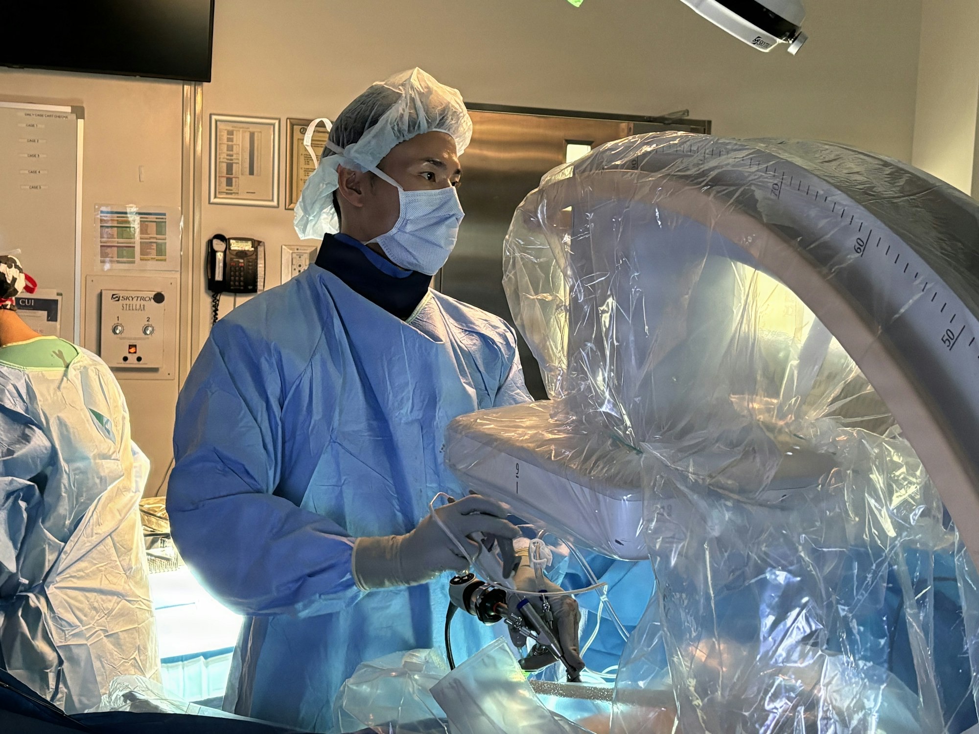 A surgeon at the controls of a robotic surgical system